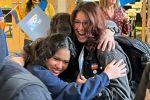students hugging